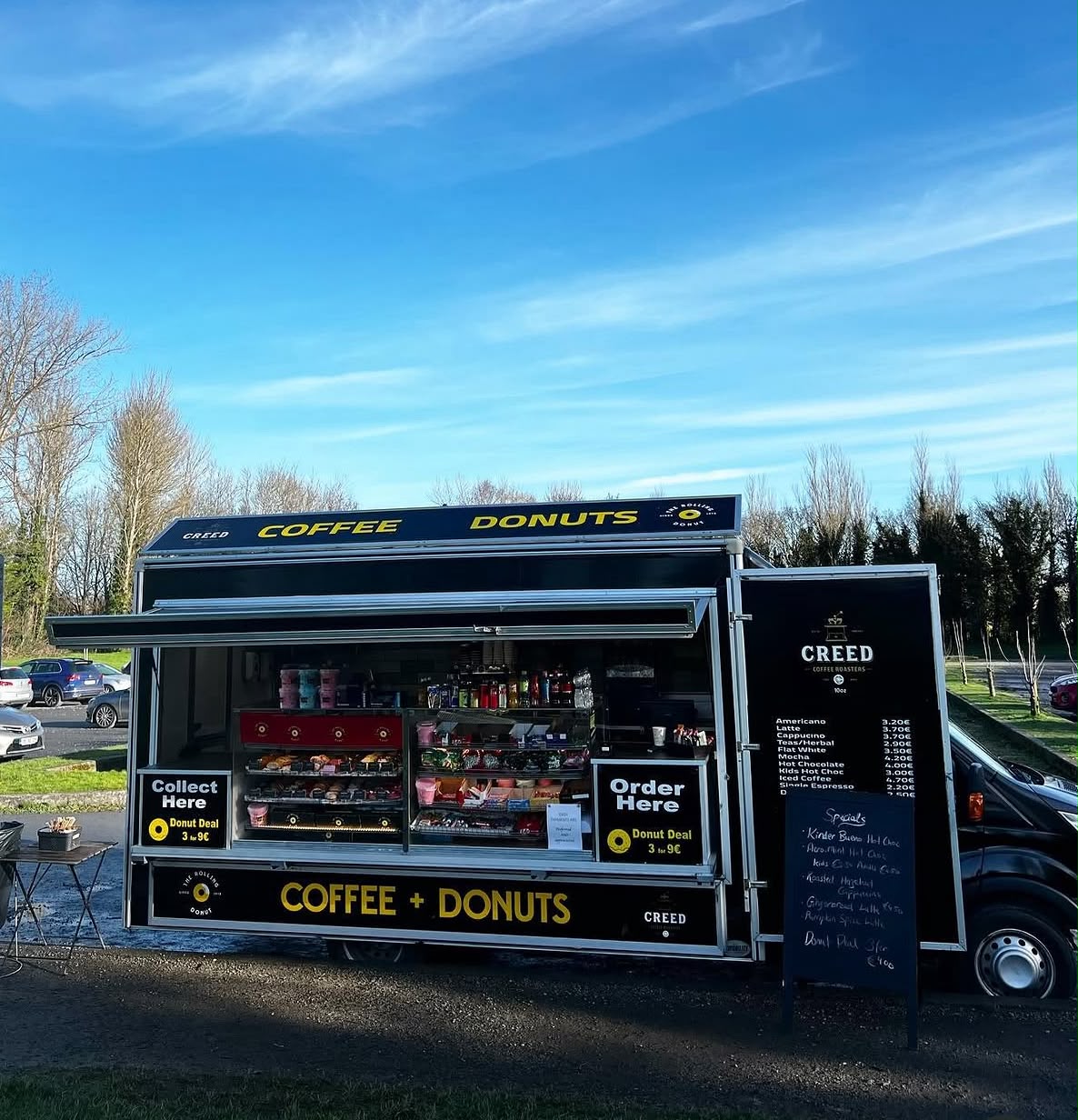 Open serving hatch with donut cabinet and Creed coffee menu
