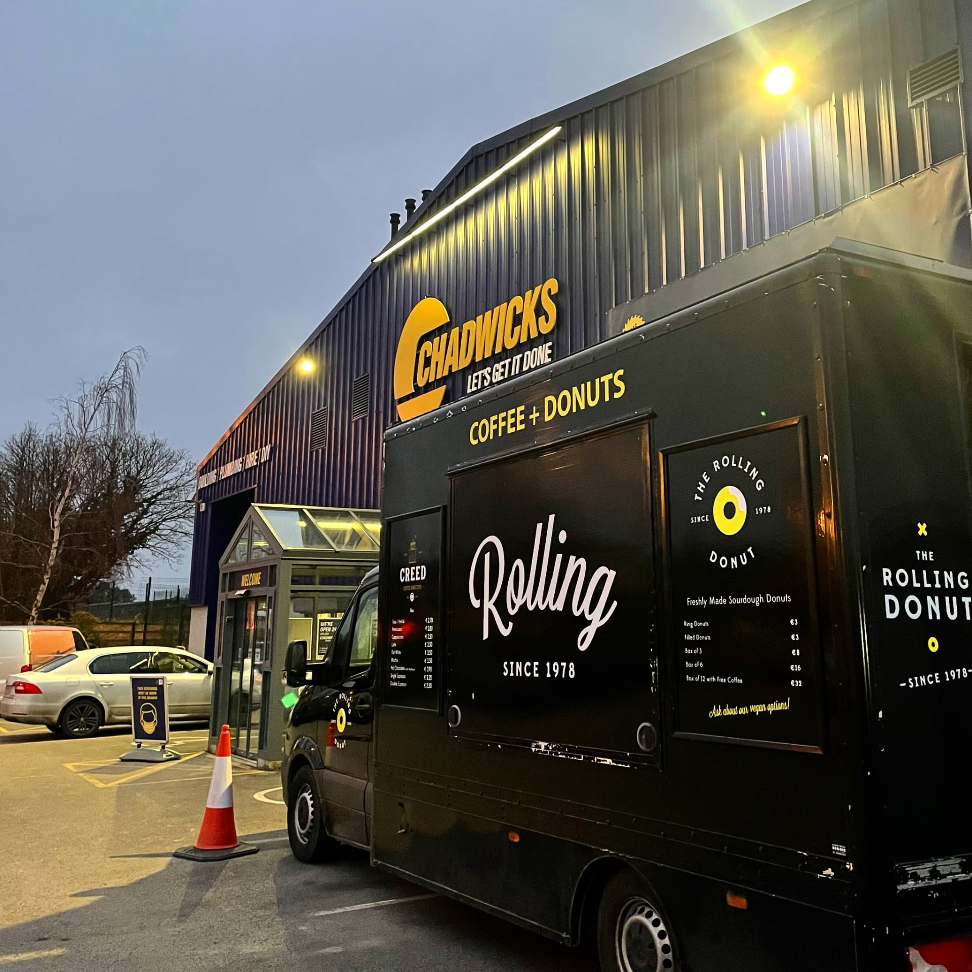 Coffee and donuts van at dusk outside a business
